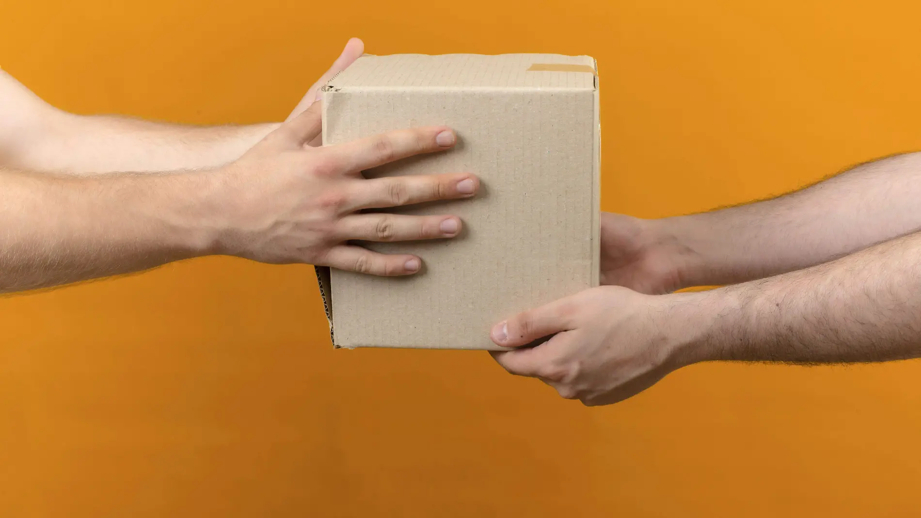 delivery-man-giving-box-package-customer-isolated-orange-side-view (1)